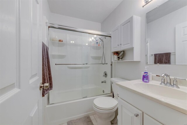bathroom featuring shower / bath combination with glass door, toilet, and vanity