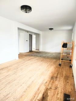 spare room featuring wood finished floors