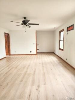 unfurnished room featuring light wood-style floors, baseboards, and ceiling fan