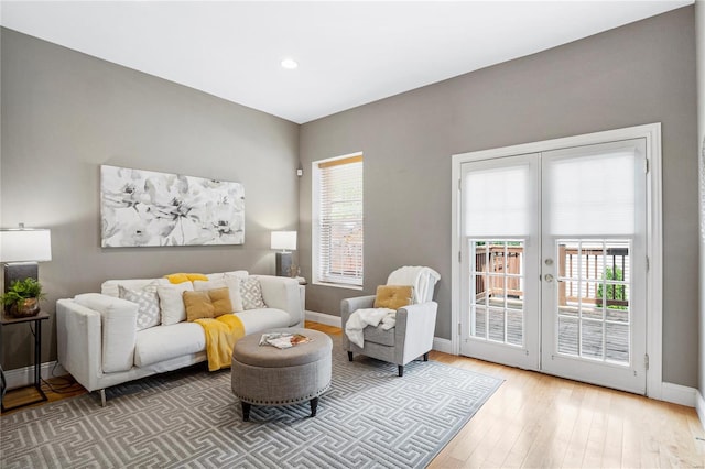interior space featuring wood finished floors, french doors, recessed lighting, and baseboards