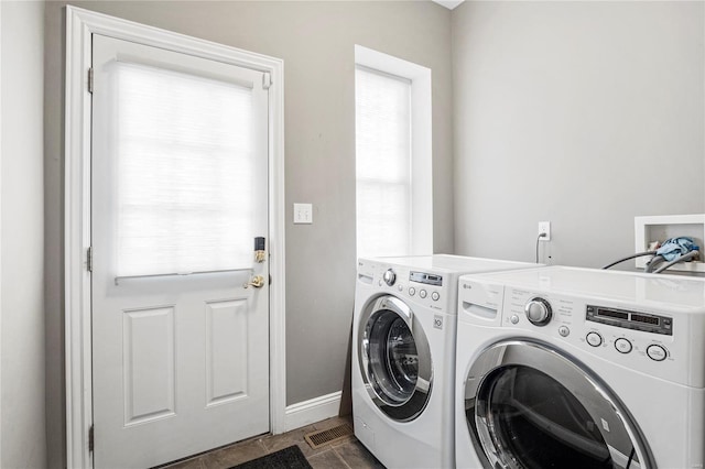 laundry area with baseboards, washing machine and clothes dryer, and laundry area