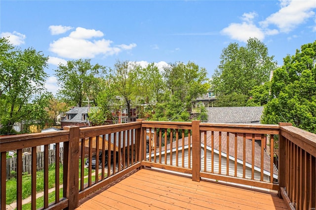 wooden terrace featuring fence