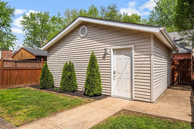 view of outbuilding featuring an outdoor structure and fence