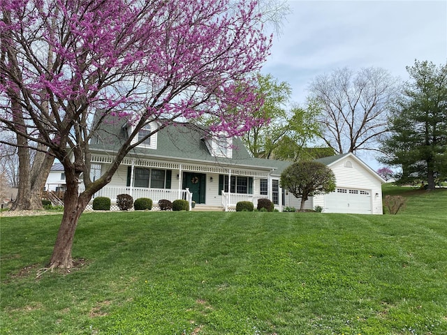 view of front of property with a front lawn, covered porch, a garage, and roof with shingles