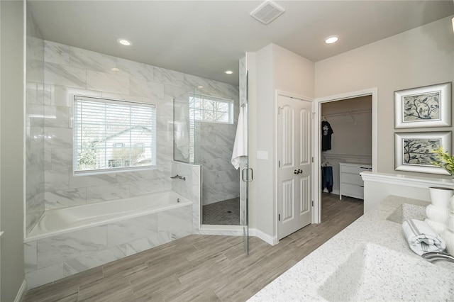 full bath featuring visible vents, a garden tub, a stall shower, and a healthy amount of sunlight