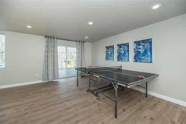 recreation room featuring baseboards, light wood-type flooring, and recessed lighting