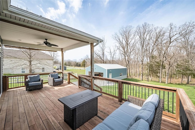 wooden terrace featuring an outdoor living space and a yard