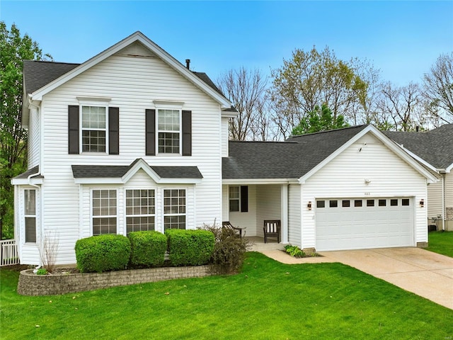 traditional-style home featuring an attached garage, roof with shingles, and a front yard