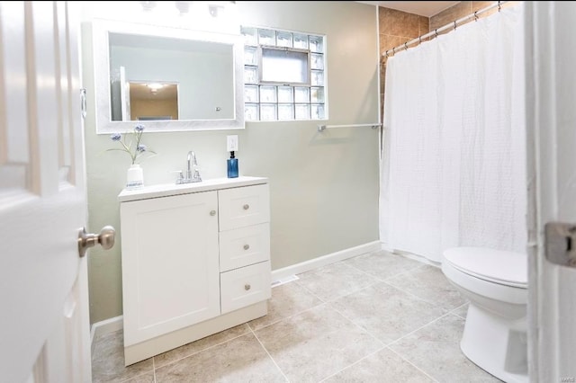 full bathroom with tile patterned floors, curtained shower, vanity, and toilet