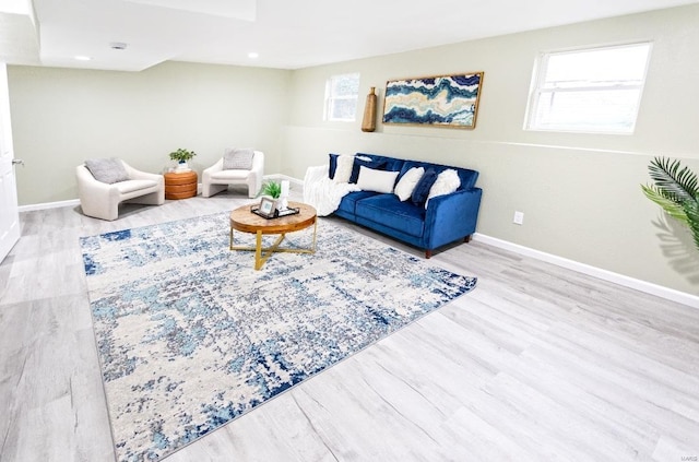 living area featuring baseboards, recessed lighting, and wood finished floors