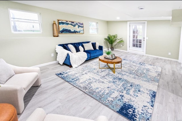 living area featuring recessed lighting, baseboards, and wood finished floors