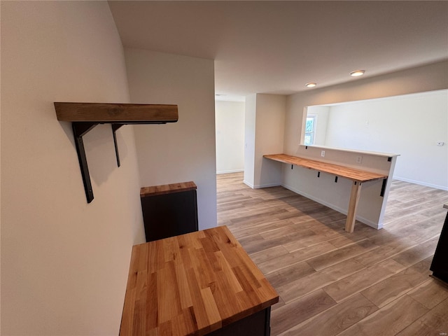 interior space featuring wood finished floors, baseboards, and recessed lighting