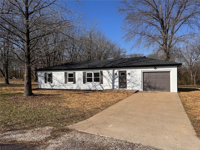 ranch-style house featuring a garage and concrete driveway