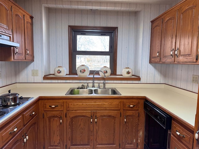 kitchen with light countertops, dishwasher, a sink, and wallpapered walls