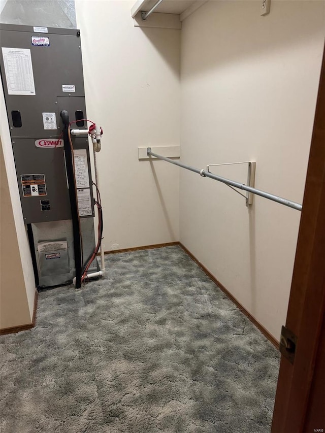 walk in closet featuring carpet floors and heating unit