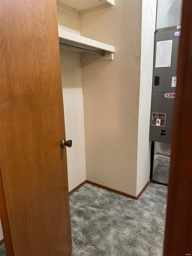 interior space featuring baseboards, heating unit, and carpet