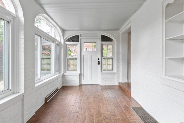 unfurnished sunroom featuring visible vents and plenty of natural light