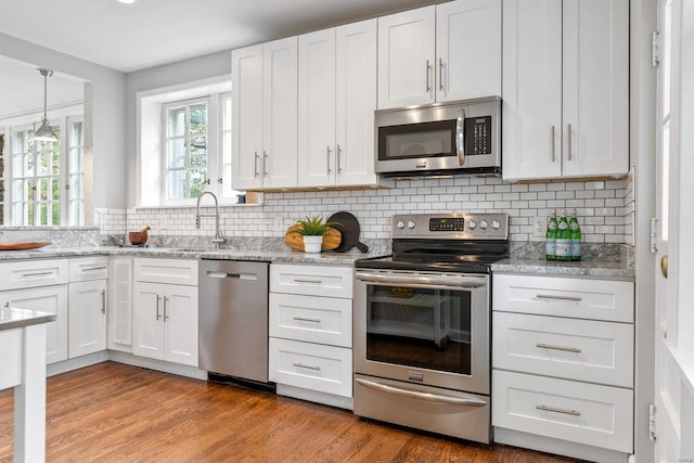 kitchen with appliances with stainless steel finishes and white cabinets