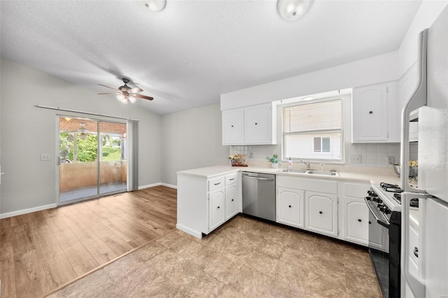 kitchen with stainless steel dishwasher, range with gas stovetop, a ceiling fan, decorative backsplash, and a sink