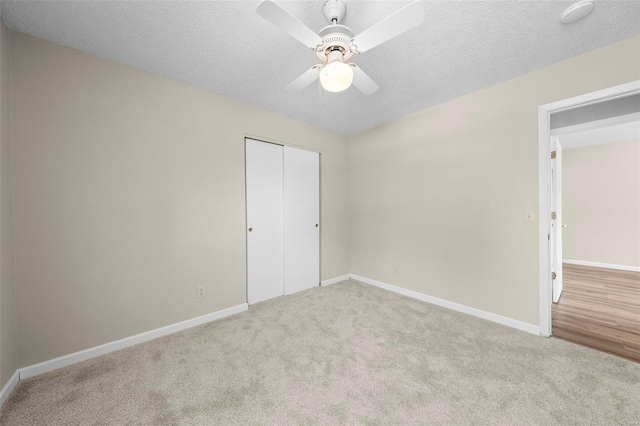 unfurnished bedroom featuring carpet flooring, baseboards, and a closet