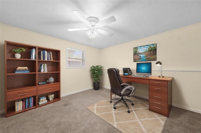 office space with a ceiling fan, baseboards, and light carpet