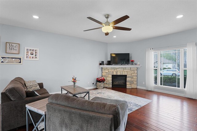 living area with recessed lighting, baseboards, dark wood finished floors, ceiling fan, and a fireplace
