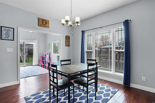 dining area featuring baseboards, an inviting chandelier, and wood-type flooring