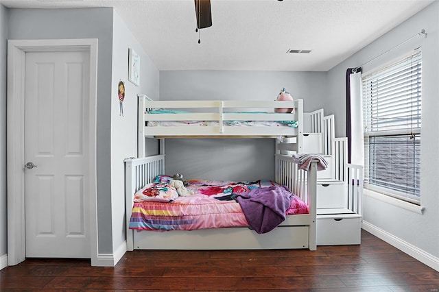 bedroom with hardwood / wood-style flooring, baseboards, and visible vents