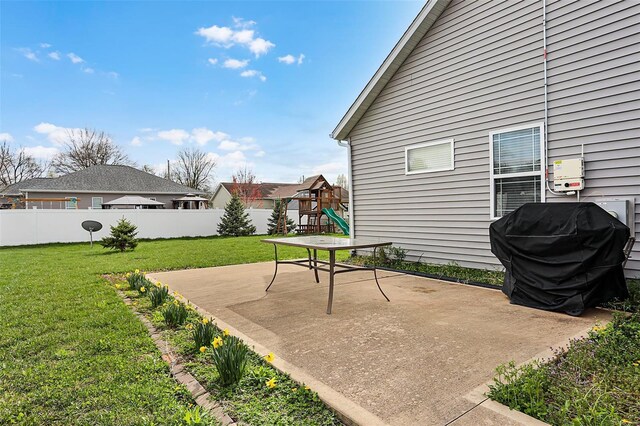 view of patio with a grill, fence, and a playground