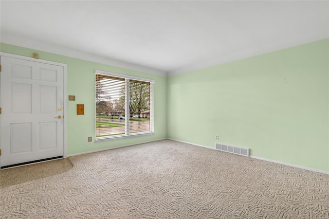 spare room featuring visible vents, baseboards, and carpet floors