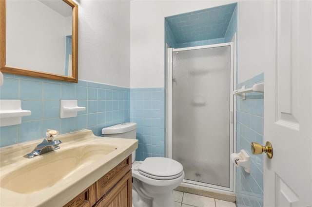 full bathroom with toilet, a stall shower, tile patterned flooring, and tile walls