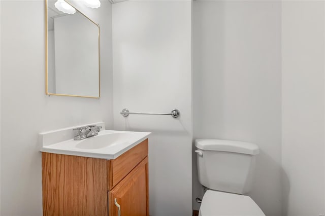 bathroom featuring toilet and vanity