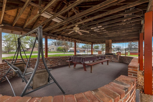 view of patio / terrace featuring a jacuzzi, glass enclosure, fence, and ceiling fan
