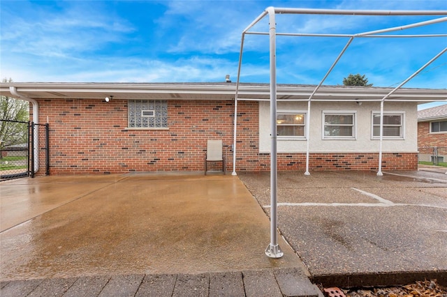 rear view of house with fence and brick siding