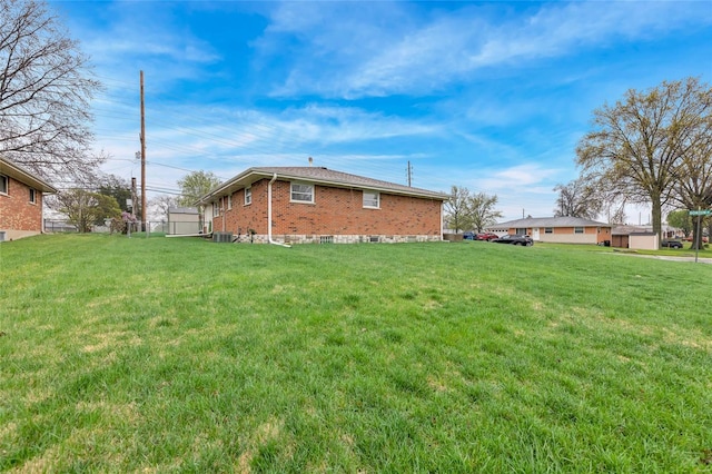 view of home's exterior featuring a yard and brick siding