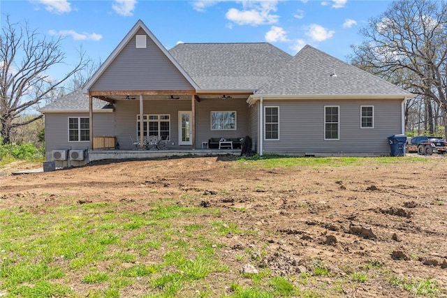 rear view of property with a shingled roof
