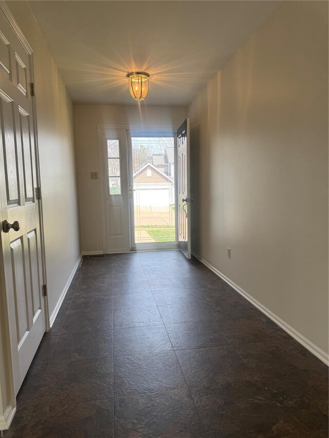 entryway featuring baseboards