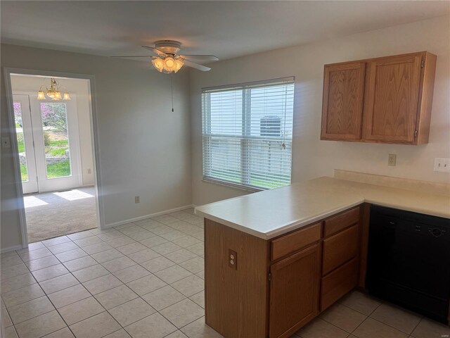 kitchen featuring light countertops, ceiling fan with notable chandelier, dishwasher, a peninsula, and brown cabinetry