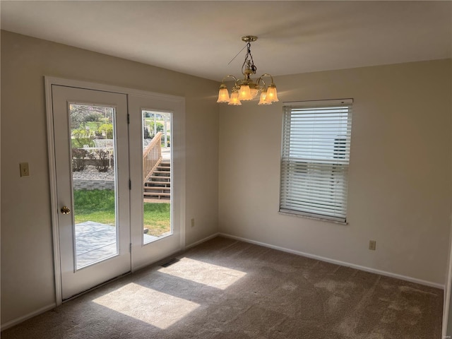 interior space featuring plenty of natural light, visible vents, carpet, and a chandelier