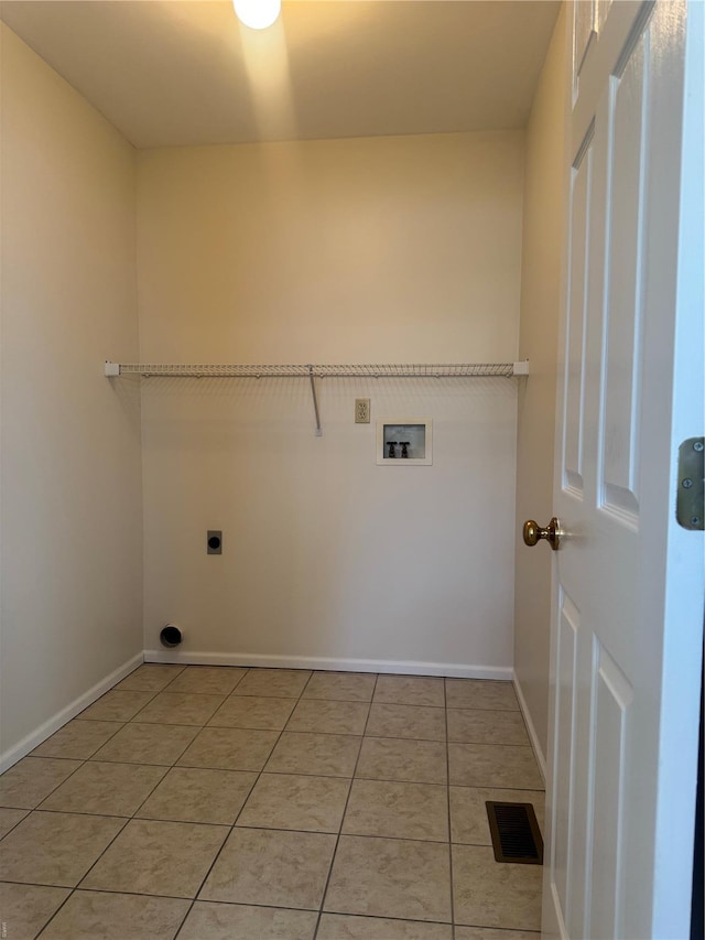 laundry area with washer hookup, electric dryer hookup, laundry area, light tile patterned floors, and visible vents