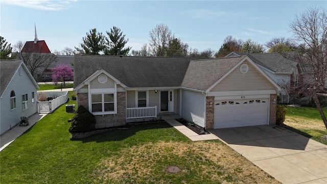 view of front of property featuring driveway, a front yard, central air condition unit, brick siding, and a garage