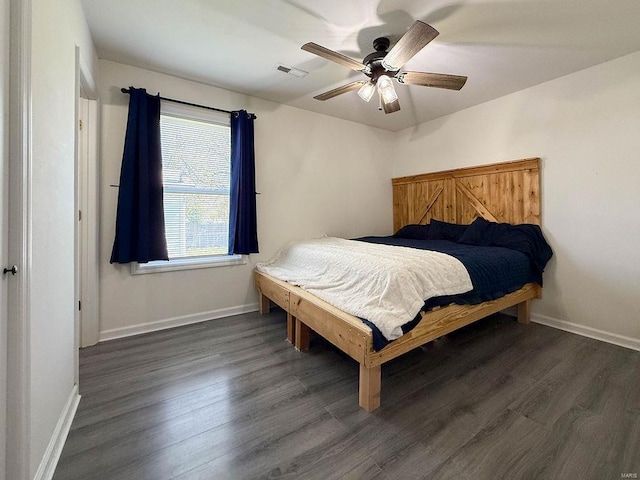 bedroom featuring wood finished floors, ceiling fan, baseboards, and visible vents