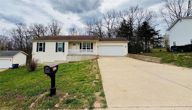 ranch-style home with a garage, a front lawn, concrete driveway, and a porch