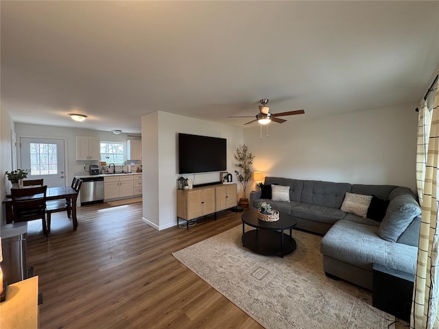 living room with ceiling fan and dark wood finished floors