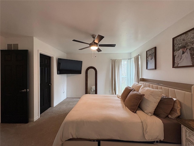 bedroom featuring arched walkways, carpet floors, visible vents, and a ceiling fan