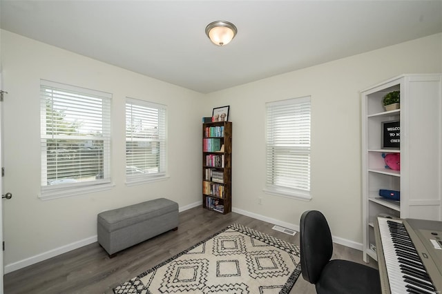 office with wood finished floors, baseboards, and visible vents