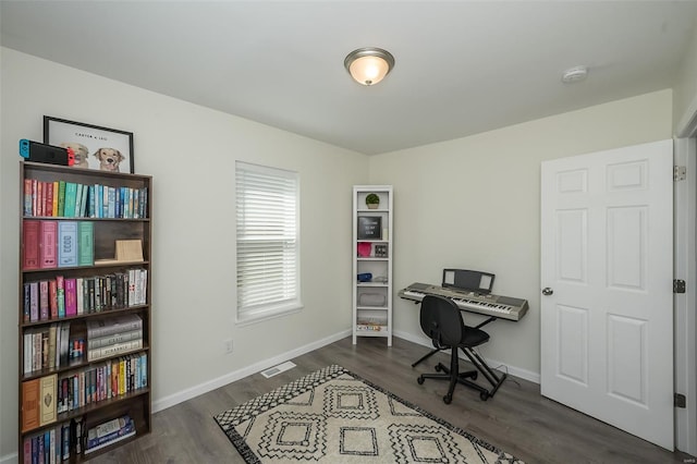 office with dark wood-style flooring, visible vents, and baseboards