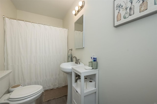 full bathroom with toilet, wood finished floors, and a shower with curtain