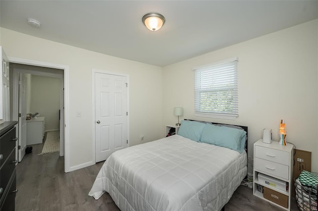 bedroom featuring dark wood-type flooring and baseboards