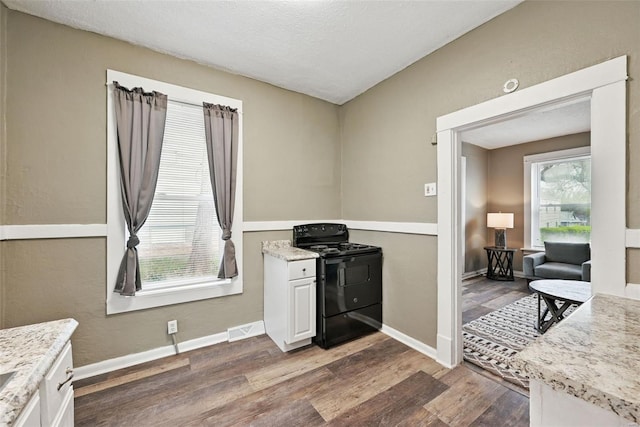 kitchen featuring visible vents, white cabinets, baseboards, dark wood-style floors, and electric range